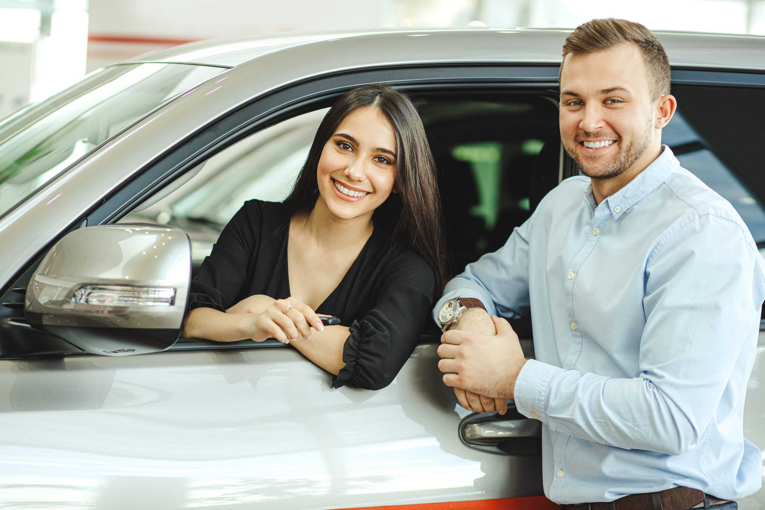 Beautiful couple buy new car in dealership